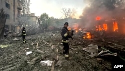 This handout photograph taken and released by the Ukrainian Emergency Service on Sept. 29, 2024, shows rescuers working at the site of a missile attack in Zaporizhzhia. 