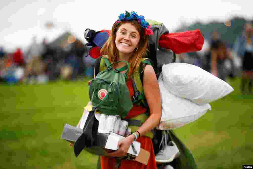 A woman arrives for the Glastonbury Festival at Worthy farm in Somerset, Britain.