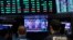 Traders listen at the New York Stock Exchange to President Donald Trump's televised speech from the White House, March 13, 2020, in New York.