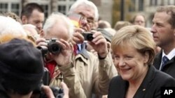 German chancellor Angela Merkel arrives for celebrations marking the 20th anniversary of Germany's reunification in Bremen, northern Germany, Sunday Oct. 3, 2010