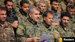 Spokesperson for the Manbij Military Council Shurfan Dawish speaks during a news conference in Manbij, Syria, June 6, 2018. 