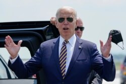 President Joe Biden responds to reporters' questions about infrastructure as he arrives at Lehigh Valley International Airport in Allentown, Pennsylvania, July 28, 2021.