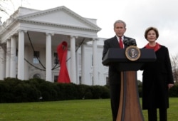FILE - President George W. Bush, with first lady Laura Bush, makes a statement on World AIDS Day at the White House in Washington, Dec. 1, 2008 in Washington.