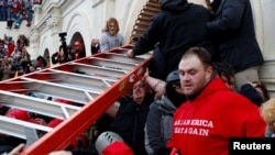 Pro-Trump protesters storm into the U.S. Capitol during clashes with police, during a rally to contest the certification of the 2020 U.S. presidential election results.