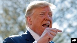 President Donald Trump speaks to members of the media on the South Lawn of the White House in Washington, before boarding Marine One helicopter, April 10, 2019. 