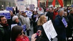 Environmental Protection Agency employees and environmental activists gather in Chicago, Feb. 6, 2017, to protest the nomination of Scott Pruitt for administrator of the agency. 