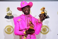 FILE - U.S. rapper Lil Nas X poses in the press room with the awards for Best Music Video and Best Pop Duo/Group Performance during the 62nd Annual Grammy Awards in Los Angeles, Jan. 26, 2020.