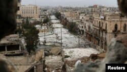 FILE - A general view shows damaged buildings along a deserted street and an area controlled by forces loyal to Syria's President Bashar Al-Assad, as seen from a rebel-controlled area at the Bab al-Nasr frontline in Aleppo, Feb. 10, 2015. 