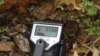 Virginia Uranium Inc. project manager Patrick Wales operates a Geiger counter in a hole next to the road near a uranium deposit on the Coles Hill Farm, Chatham, Va., Jan. 13, 2013.