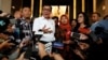 Baiq Nuril Maknun, a school bookkeeper who was jailed after she tried to report sexual harassment, reacts to journalists as she arrives at the Law and Human Rights Ministry office, in Jakarta, Indonesia, July 8, 2019.