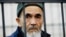 FILE - Uzbek journalist Azimjon Askarov, who has been jailed for life, looks through metal bars in a courtroom during hearings in Bishkek, Kyrgyzstan, Oct. 11, 2016.