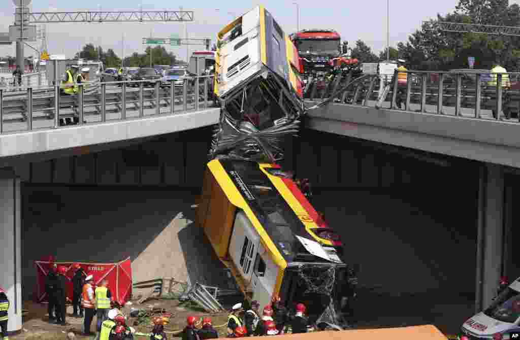 The wreckage of a Warsaw city bus is seen after it crashed off an overpass, killing one person and injuring about 20 people, in Warsaw, Poland.