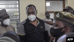 FILE - Tanzania Chadema party chairman Freeman Mbowe stand in the dock at Kisutu Resident Magistrate's Court in Dar es Salaam on Aug, 06, 2021. 