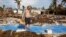 Billy “The Kid” Quinn, 48, assesses the damage atop a blue slab where his home used to be in Islamorada's Seabreeze Trailer Park. (R. Taylor/VOA)