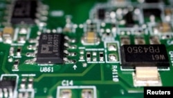 FILE - Semiconductors are seen on a printed circuit board in this illustration picture taken February 17, 2023. (REUTERS/Florence Lo/Illustration/File Photo)