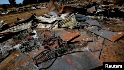 A bicycle lies amongst the debris of houses destroyed in post election violence in the village of Rukuini near Eldoret, northwest of Nairobi, Kenya, Jan. 7, 2008. 