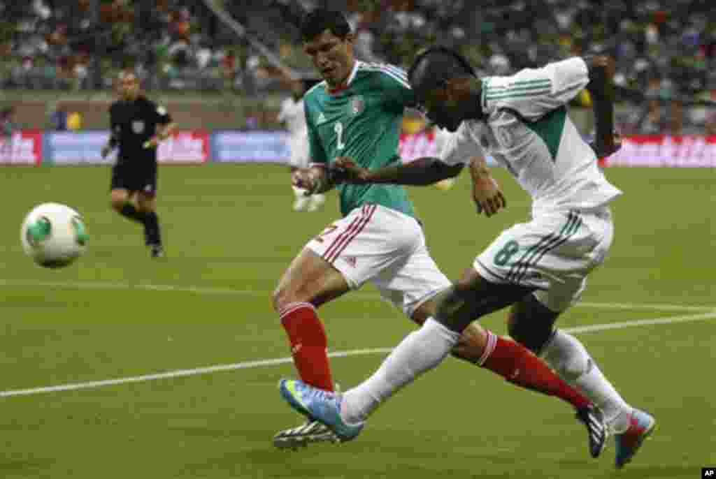 Nigeria forward Aide Brown Ideye (8) kicks the ball away from Mexico defender Francisco Rodriguez (2) during the first half of a soccer game on Friday, May 31, 2013, in Houston.