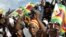 Zimbabwe political supporters wave flags in Gutu, a rural town 220 Km's south-east of the capital [Harare], (File photo).