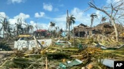 In this handout photo provided by the Office of the Vice President, toppled trees and structures are scattered due to Typhoon Rai in Siargao island, Surigao del Norte, southern Philippines, Dec. 19, 2021. (Office of the Vice President via AP)