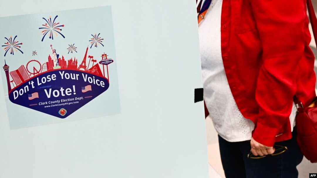 A voter prepares to cast a ballot on an electronic voting machine inside a vote center on Election Day during the Nevada 2024 presidential primary election in Las Vegas, Nevada, on Feb. 6, 2024. 