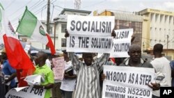 Trade union members display placards during a protest, in Lagos, Nigeria, Wednesday, Nov. 10, 2010. Trade unions protesting Nigeria's minimum wage have called a warning strike across the oil-rich nation. Wednesday's strike by the Nigerian Labor Congress a