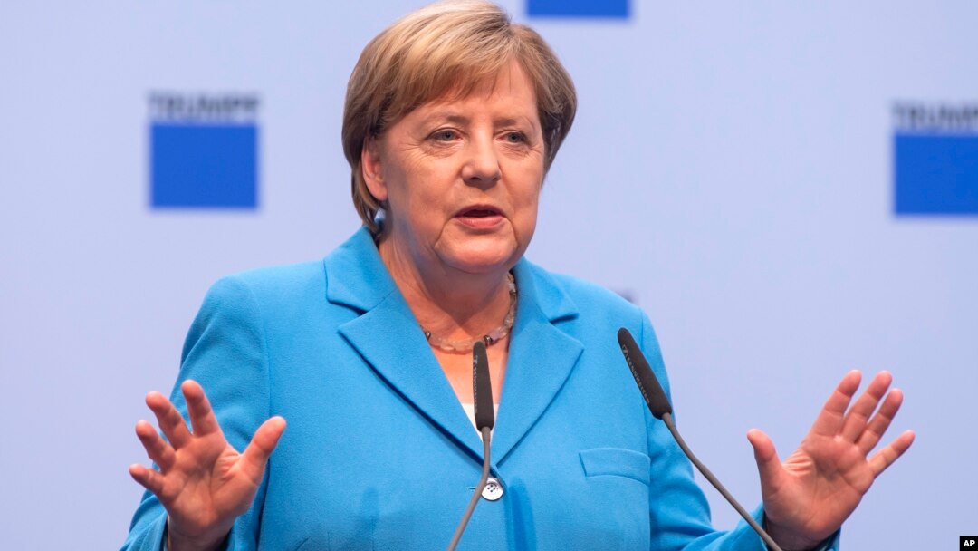 German chancellor Angela Merkel gestures during a discussion with TRUMPF employees in Neukirch, eastern Germany, Aug. 16, 2018.