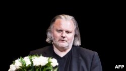 FILE - Norwegian dramatist Jon Fosse receives the Ibsen Prize from Juror Eirik Stuboe on September 10, 2010 at the National Theatre in Oslo during the last day of the Ibsen Festival.