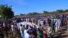 People attend a funeral for those killed by suspected Boko Haram militants in Zaabarmar, Nigeria, Sunday, Nov. 29, 2020. Nigerian officials say suspected members of the Islamic militant group Boko Haram have killed at least 40 rice farmers and…