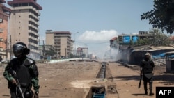 FILE - Police officers in riot gear work during mass protests in Conakry, Guinea, Oct. 23, 2020. The death of a man protesting June 1, 2022, has led to an investigation in Guinea.