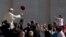 A worshipper tosses a hat into the air as Pope Francis arrives for his weekly general audience in St. Peter's Square, at the Vatican, in Rome, June 10, 2015.