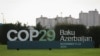 A view shows a sign of the COP29 United Nations Climate Change Conference with a backdrop of the cityscape in Baku, Azerbaijan, Oct. 31, 2024. 