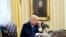 FILE - President Donald Trump speaks on the phone in the Oval Office of the White House in Washington, Jan. 28, 2017. Desperate for a legislative victory, Trump is upping the pressure on lawmakers to act on several initiatives.