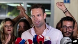 FILE - Stefanos Kasselakis, then-leader of Greece's main opposition party Syriza, speaks to supporters outside the party's headquarters in Athens, Sept. 25, 2023.