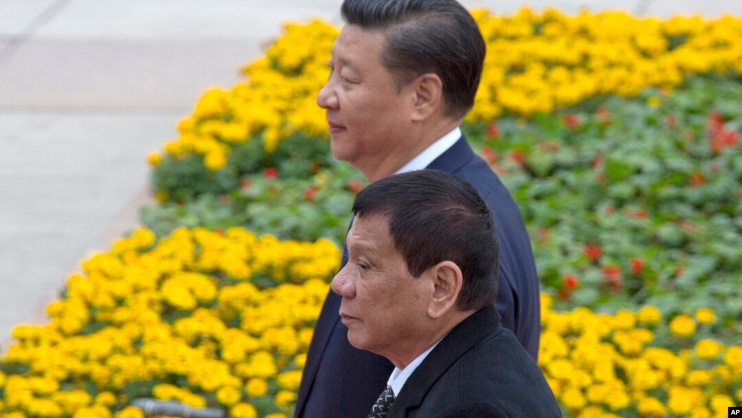 Philippine President Rodrigo Duterte, front, walks with Chinese President Xi Jinping during a welcome ceremony outside the Great Hall of the People in Beijing, China, Oct. 20, 2016.