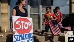 People participate in a protest against recent U.S. immigration policy that separates children from their families when they enter the United States as undocumented immigrants, in front of a Homeland Security facility in Elizabeth, New Jersey, June 17, 20