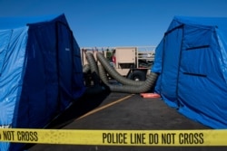 Large generators push air through tubes into tents being used by investigators to examine evidence from the Conception at the Santa Barbara Harbor, Sept. 4, 2019, in Santa Barbara, Calif.