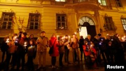Demonstrators hold candles in a protest demanding no government participation for the far right, in Vienna, Austria, Nov. 15, 2017.