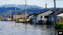 FILE - Floodwater inundates homes in Sumas, Wash., on Nov. 17, 2021.