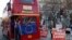 Anti-Brexit protesters on board a hired red London bus demonstrate as they drive past the Houses of Parliament in London, Jan. 28, 2019. 