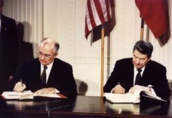 FILE - U.S. President Ronald Reagan and Soviet President Mikhail Gorbachev sign the Intermediate-Range Nuclear Forces Treaty at the White House, Dec. 8, 1987.