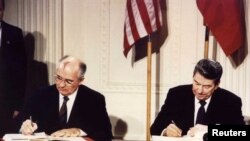 FILE - U.S. President Ronald Reagan and Soviet President Mikhail Gorbachev sign the Intermediate-Range Nuclear Forces Treaty at the White House, Dec. 8, 1987.