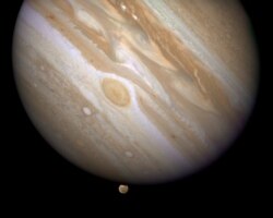 FILE - The planet Jupiter is shown with one of its moons, Ganymede (bottom), in this NASA handout taken April 9, 2007.
