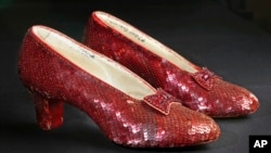 FILE - Sequin-covered ruby slippers worn by Judy Garland in 'The Wizard of Oz' appear at the offices of Profiles in History in Calabasas, Calif. on Nov. 9, 2001.