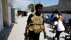 FILE - Jimmy Chérizier, a former elite police officer known as Barbecue who leads the G9 and Family gang, walks away after speaking to journalists in the Delmas 6 neighborhood of Port-au-Prince, Haiti, Monday, March 11, 2024.