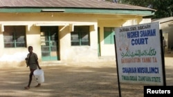 FILE - A sign is seen outside the Higher Shariah Court in the northern Nigerian city of Gusauthe, Nov. 30, 2002.