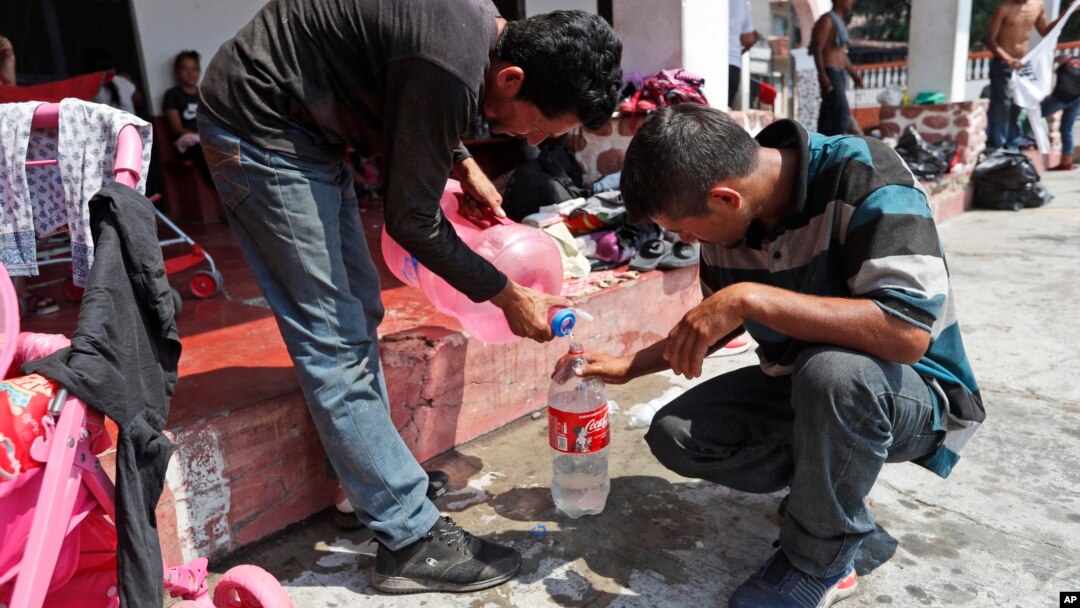 Central American migrants traveling in a caravan to the U.S. collect water as they rest at the San Francisco Catholic church in Tonala, Chiapas State, Mexico, April 23, 2019.