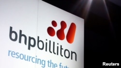 FILE - A promotional sign adorns a stage at a BHP Billiton function in central Sydney, Australia August 20, 2013.