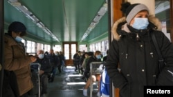 People wear masks inside a vaporetto in Venice, Italy, March 15, 2021. 