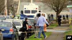 A student is evacuated by police from Rosemary Anderson High School in Portland, Oregon, Dec., 12, 2014.