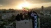 People wave flags adopted by the new Syrian rulers during celebrations in Umayyad Square, after the ousting of Syria's Bashar al-Assad, in Damascus, Syria, Dec. 20, 2024.